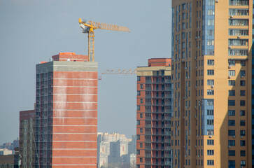 Fototapeta premium Construction of multi-storey brick houses. The process of construction in the metropolis.