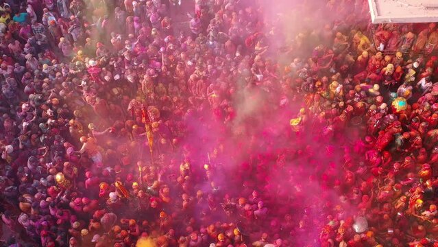 Barsana, India - 28 February 2023: Aerial view of people celebrating the holy colour festival in the street in Barsana, Uttar Pradesh, India.