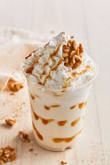 Cinnamon Walnut milkshake with cream served in glass isolated on table top view healthy morning drink