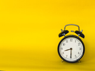 copy space for product display montage. , Ringing twin bell vintage classic alarm clock Isolated on yellow colourful trendy modern background.