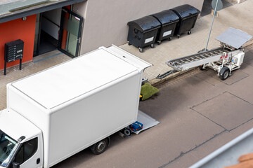 Mover service lifting ladder cargo crane platform vehicle van parked at city street. Retractable...