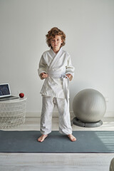 Serious boy during judo training at home