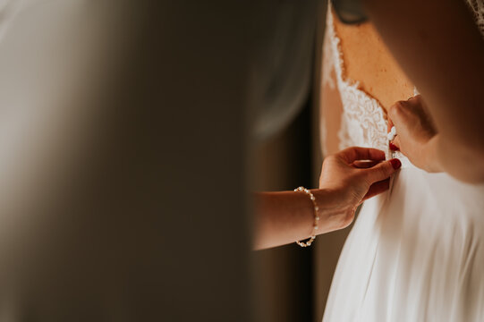 bride dress being buttoned