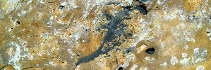 Hverir, Iceland. A surreal, bare orangy-red, geothermal area at the foot of Namafjall. Full of fumaroles, mud pools, steam vents. It's on Route 1. It is also called Namaskard Hverir.