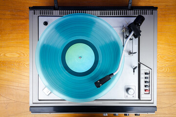 Vintage turntable vinyl record player with turquoise vinyl
