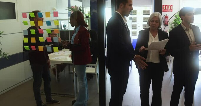 Multi generational business colleagues working inside real estate agency office - Entrepreneurs people sharing ideas at teamwork meeting