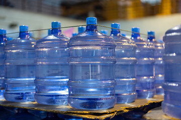 Plastic bottle or gallon of purified drinking water inside drinking water or beverage factory which...
