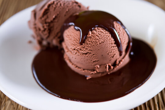 Indulge in the pure bliss of velvety chocolate ice cream, generously drenched in a delectable, rich chocolate sauce. A sweet symphony of cocoa perfection