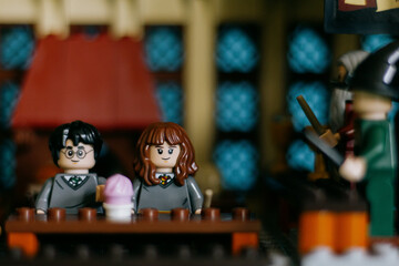 Naklejka premium Spain - 10 Sept 2023: Harry Potter and Hermione Granger Lego figures in the Great Hall of Hogwarts. 