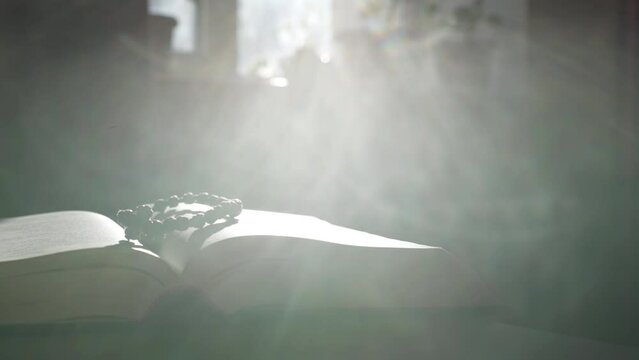 Light falls on the holy bible. Feeling the presence of God
