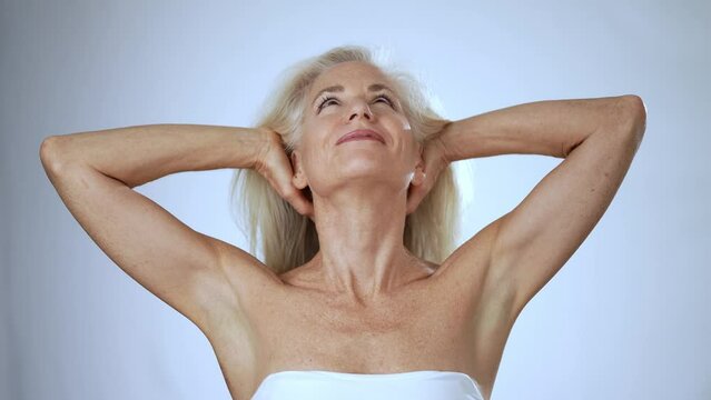 Closeup Portrait Of Smiling Happy Mature, Senior, Fit Woman Happy With Outstretched Arms Celebrating Great Freedom Hair Flying Isolated On White Background In Slow Motion.