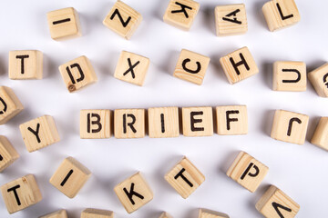 BRIEF. Wooden alphabet letter blocks on a white background