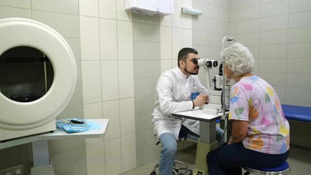An ophthalmologist checks the patient's vision.