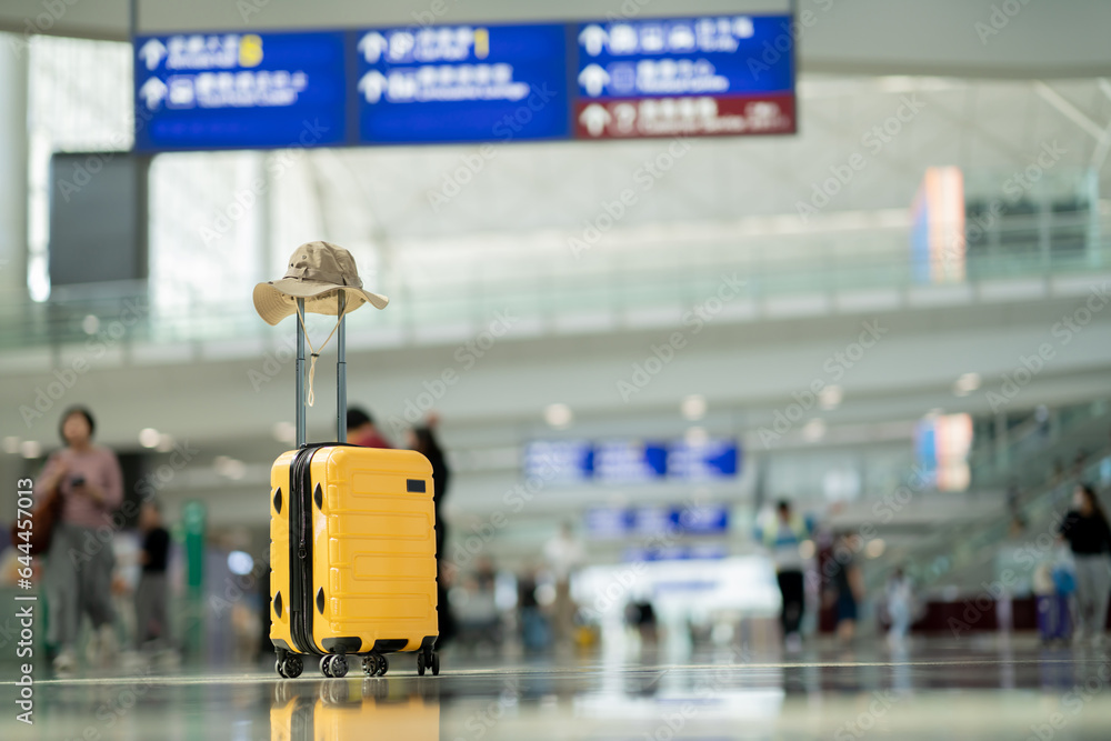 Wall mural The suitcases in an empty airport hall, traveler cases in the departure airport terminal waiting for the area, vacation concept, blank space for text message or design