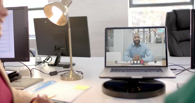Laptop with video call with african american businessman on screen