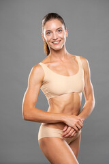 Fitness portrait of young muscular woman in sports underwear