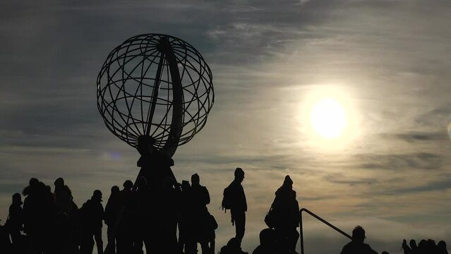 Nordkapp. Silhouettes of people at the northernmost point of Europe. People at the sphere or globe, in North cape, Finnmark, Norway. Wonderful trip. Epic Panorama Nature.