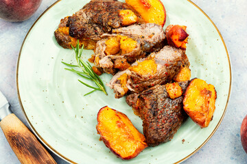 Roasted meat beef steak with peach.