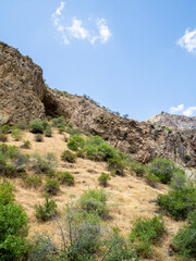 cliffs and rocks around medieval rock monastery of Geghard on sunny summer day, Armenia