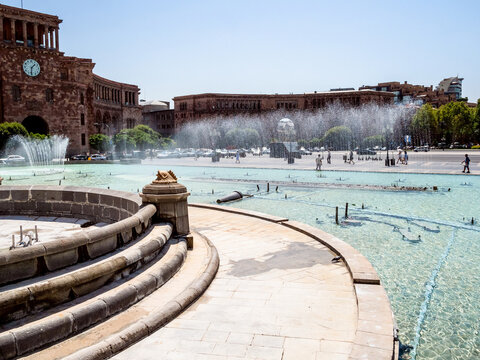 fountains in water pool on Republic Square in Yerevan city on sunny summer day. Republic Square is the central town square