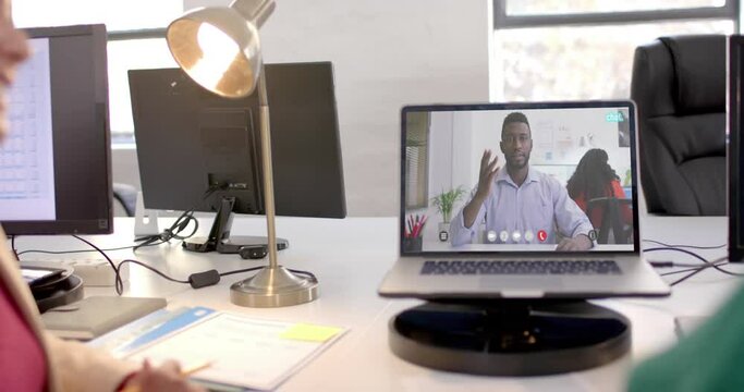 Laptop with video call with african american businessman on screen