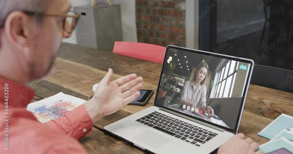 Canvas Prints Caucasian businessman on laptop video call with caucasian female colleague on screen