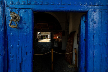 Blue wooden portal with the open access door