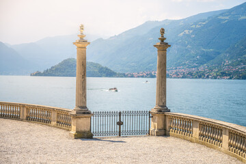 Ornamental gate with roman columns to Como Lake, Italian: Lago di Como, Bellagio, Lombardy, Italy