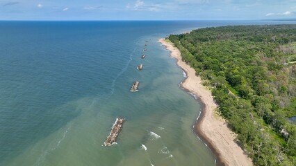 Beautiful sandy beach and coastline of barrier island on Lake Erie Pennsylvania Presque Isle State Park with nature preserve in sunshine on summer day with blue sky and calm waves and surf