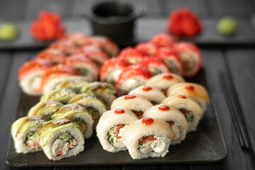 Sushi set. Philadelphia roll, california with fresh ingredients on black background. Sushi menu. Japanese food concept.