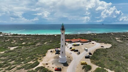 Aerial view the California Lighthouse, a historical landmark along the coast on the island of Aruba. - Powered by Adobe