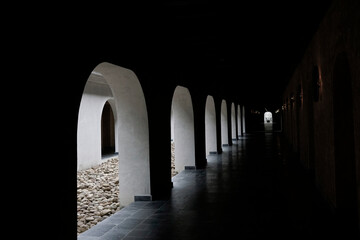 Light shining through traditional arch window hallway