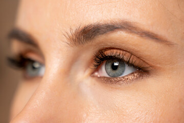Close-up of the blue eyes of a young woman with large eyelashes. 