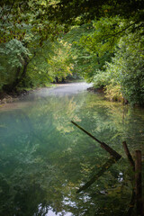 mist over clean transparent cold turquoise river water in Slovenian alps