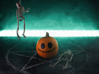 Halloween pumpkin and hanging skeleton on pentagram background