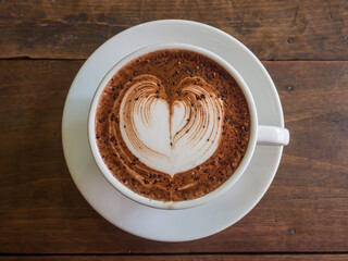 hot chocolate in a white cup on a wooden table