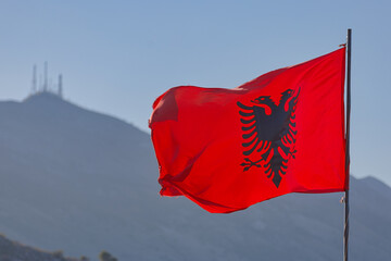 Albanian Flag Waving in Shkoder with Skadar Mountains Backdrop