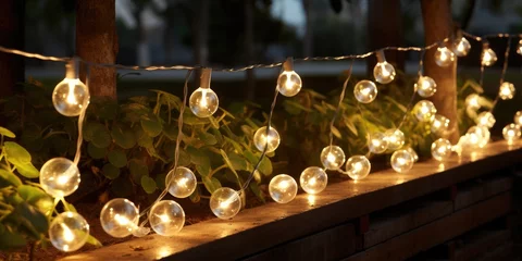 Foto op Plexiglas Close-up of a street garland with warm light on patio late at night. Generative AI © 22_monkeyzzz