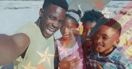 Animation of flag of america over african american man taking selfie with family at beach - Powered by Adobe