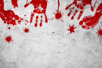 Bloody handprints and footprints with splashes of blood on concrete background