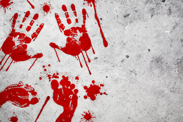 Bloody handprints and footprints with splashes on concrete table. Top view. - Powered by Adobe