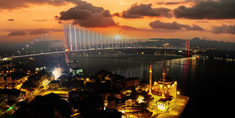 Aerial view of Ortakoy mosque, also known as Buyuk Mecidiye, backgrounded by 15 July Martyrs bridge...