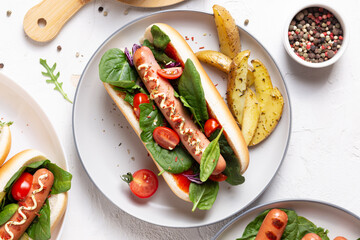 French hot dog with grilled sausage and fried potatoes for dinner