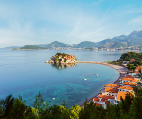 Fototapeta premium The morning view of Sveti Stefan sea islet with pink beach (Montenegro, near Budva). People are unrecognizable.