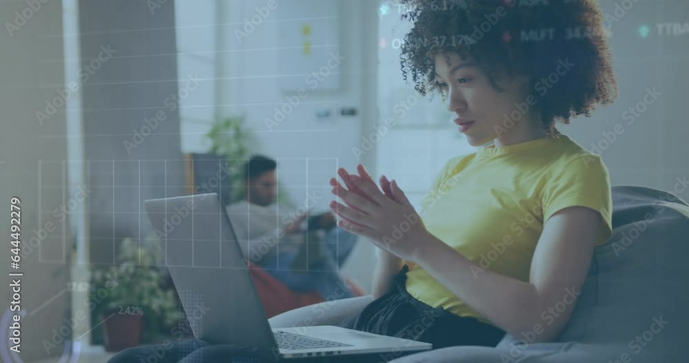 Wall mural Animation of statistical data processing on thoughtful african amercan woman using laptop at office