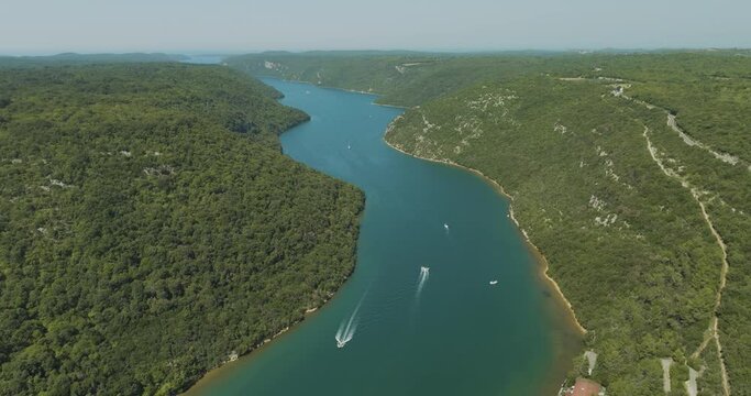 Aerial view of boats sailing along the Limski Fjord (Canal di Leme) in Sveti Lovrec, Istria, Croatia.