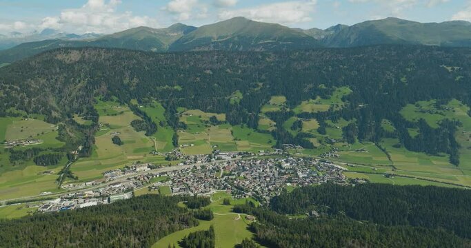 Aerial view of San Candido town as seen from Croda dei Baranci (Birkenkofel) mountain peak on the Dolomites range, Innichen, Trentino, South Tyrol, Italy.