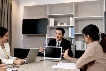 Businesspeople discussing at conference office desk, senior businessman showing laptop computer for presentation at group board meeting, agreement on negotiation deal, successful company teamwork.