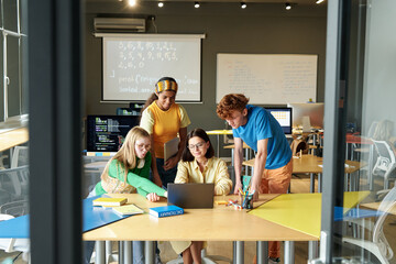 Teacher teaching information technology to students in the classroom at school