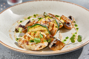 Macro shot of grilled turkey fillet steak, capturing the rich textures and colors. Served with zucchini, mushrooms, and green sauce on a white ceramic plate. Perfect for a balanced diet